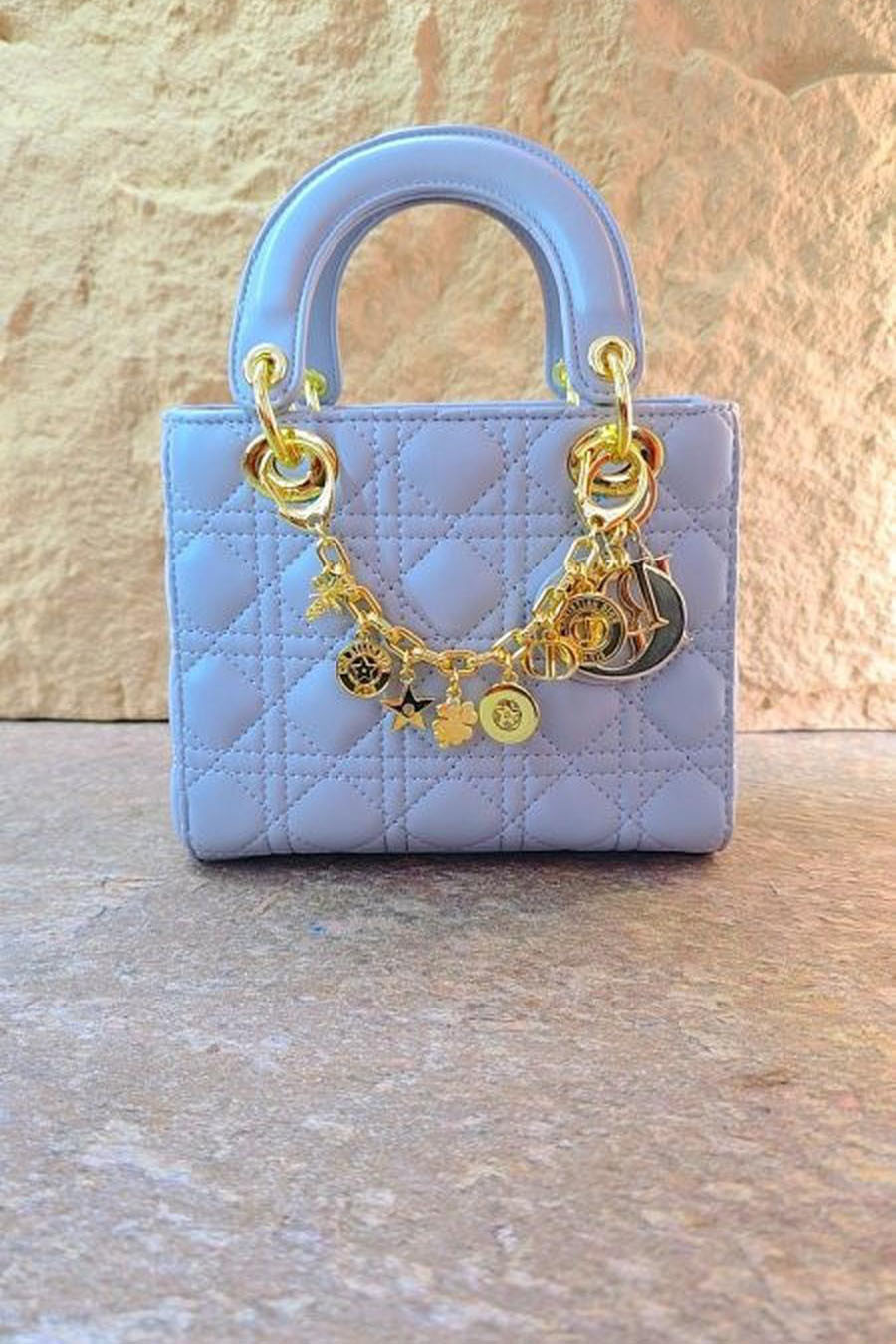 Mini Dior bag with gold accessories, including box